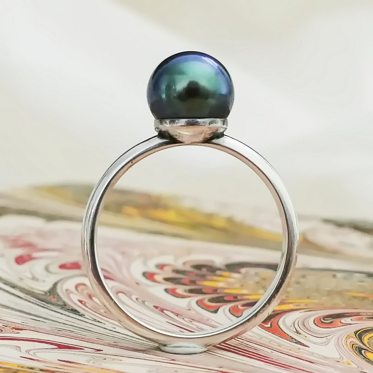 Inger- Pearl Solitaire Ring Features a Blue Green Akoya Pearl Set in Solid Sterling Silver.