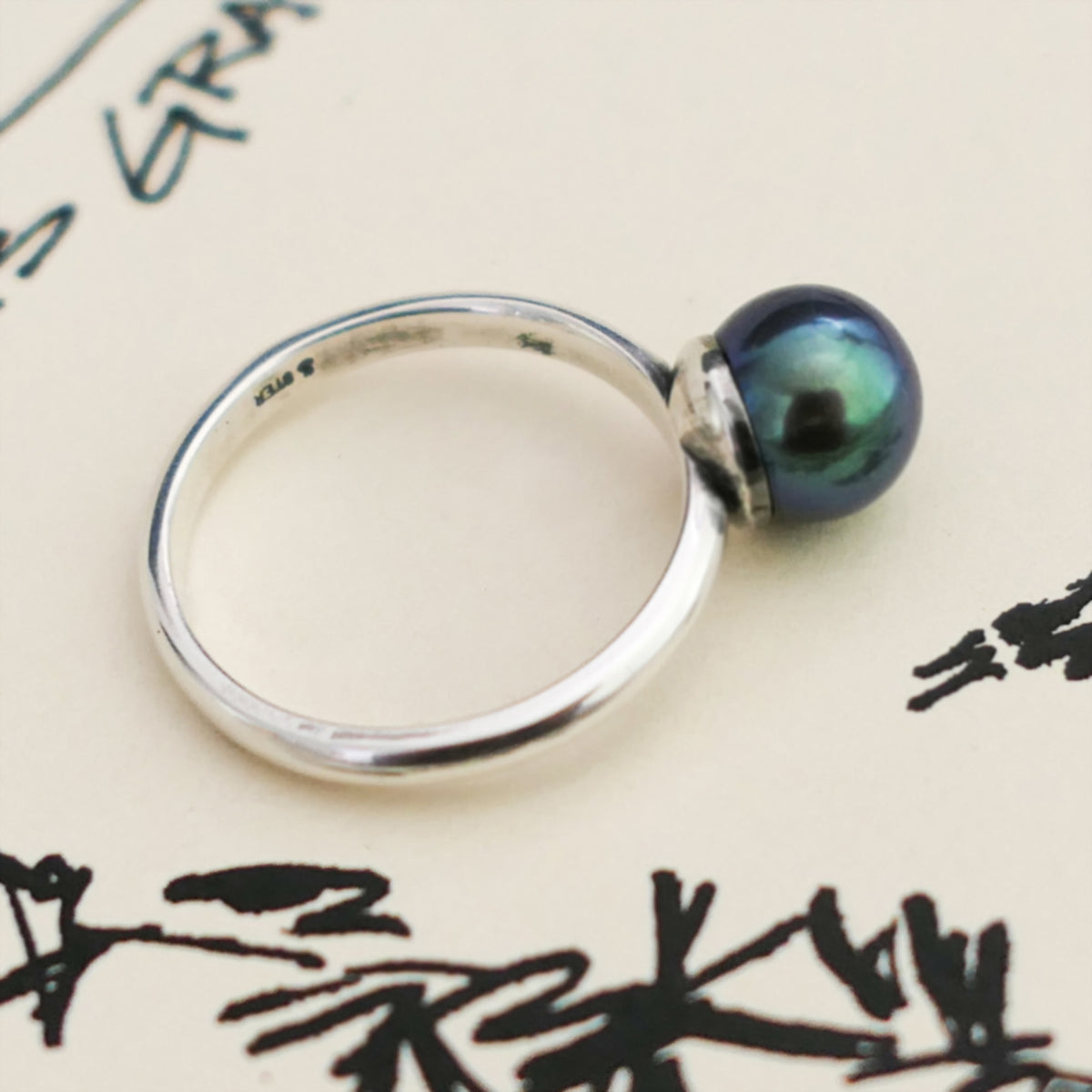 Inger- Pearl Solitaire Ring Features a Blue Green Akoya Pearl Set in Solid Sterling Silver.