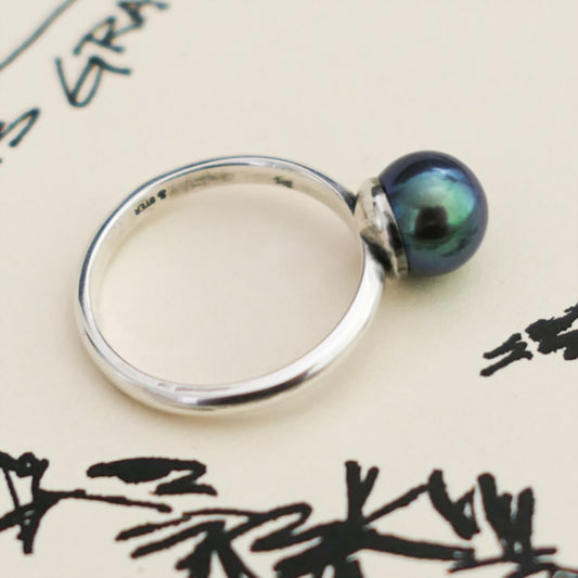 Inger- Pearl Solitaire Ring Features a Blue Green Akoya Pearl Set in Solid Sterling Silver.