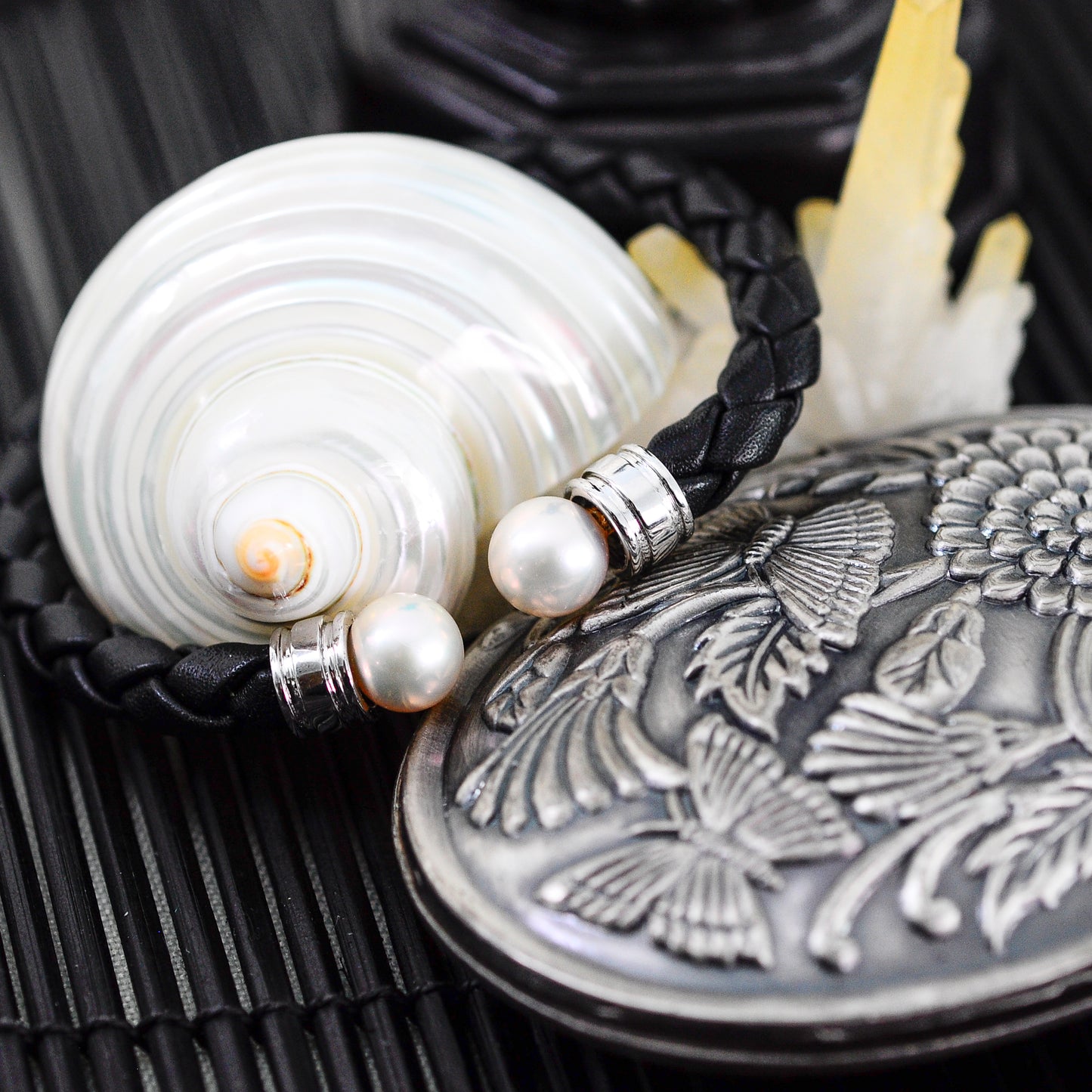 Ciara - Cuff Bracelet Features Perfectly Matched Pearls Set on a Flexible, Braided Leather and Sterling Silver Cuff.