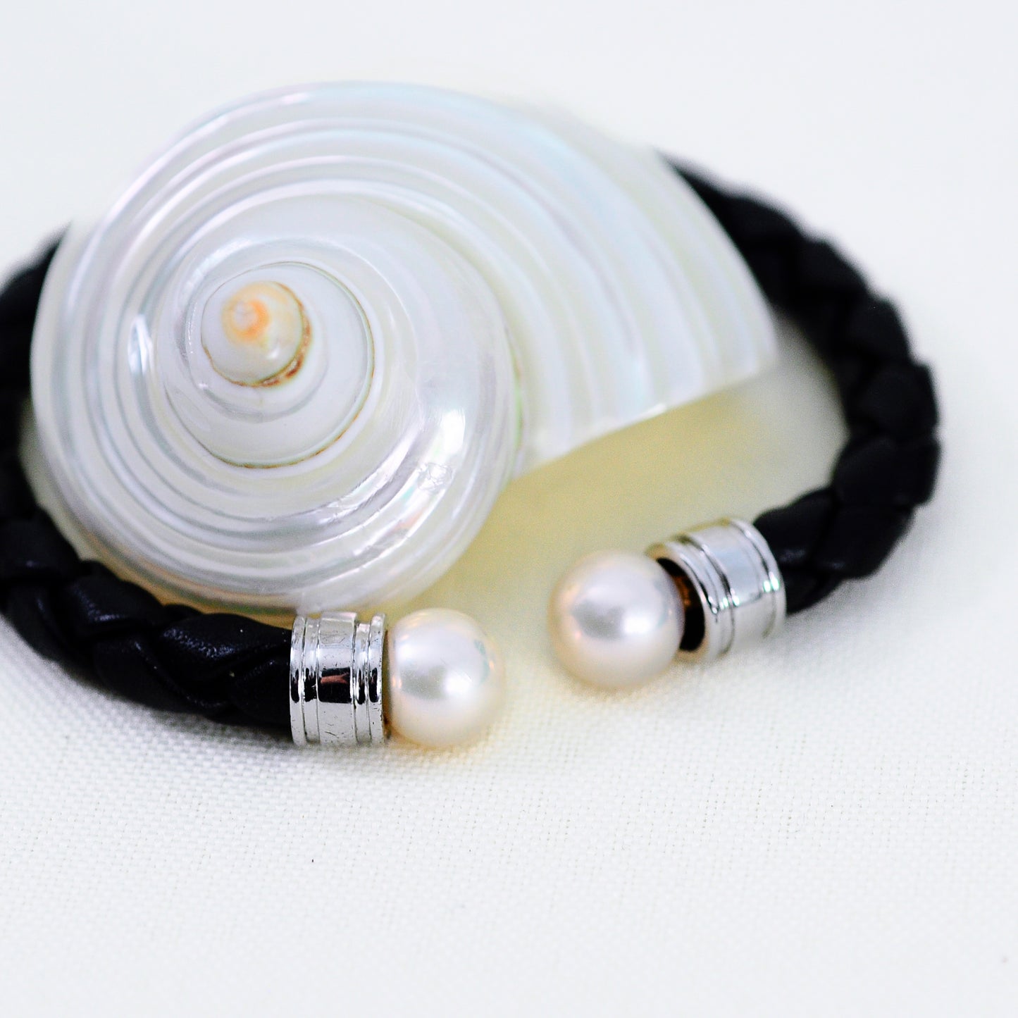 Ciara - Cuff Bracelet Features Perfectly Matched Pearls Set on a Flexible, Braided Leather and Sterling Silver Cuff.